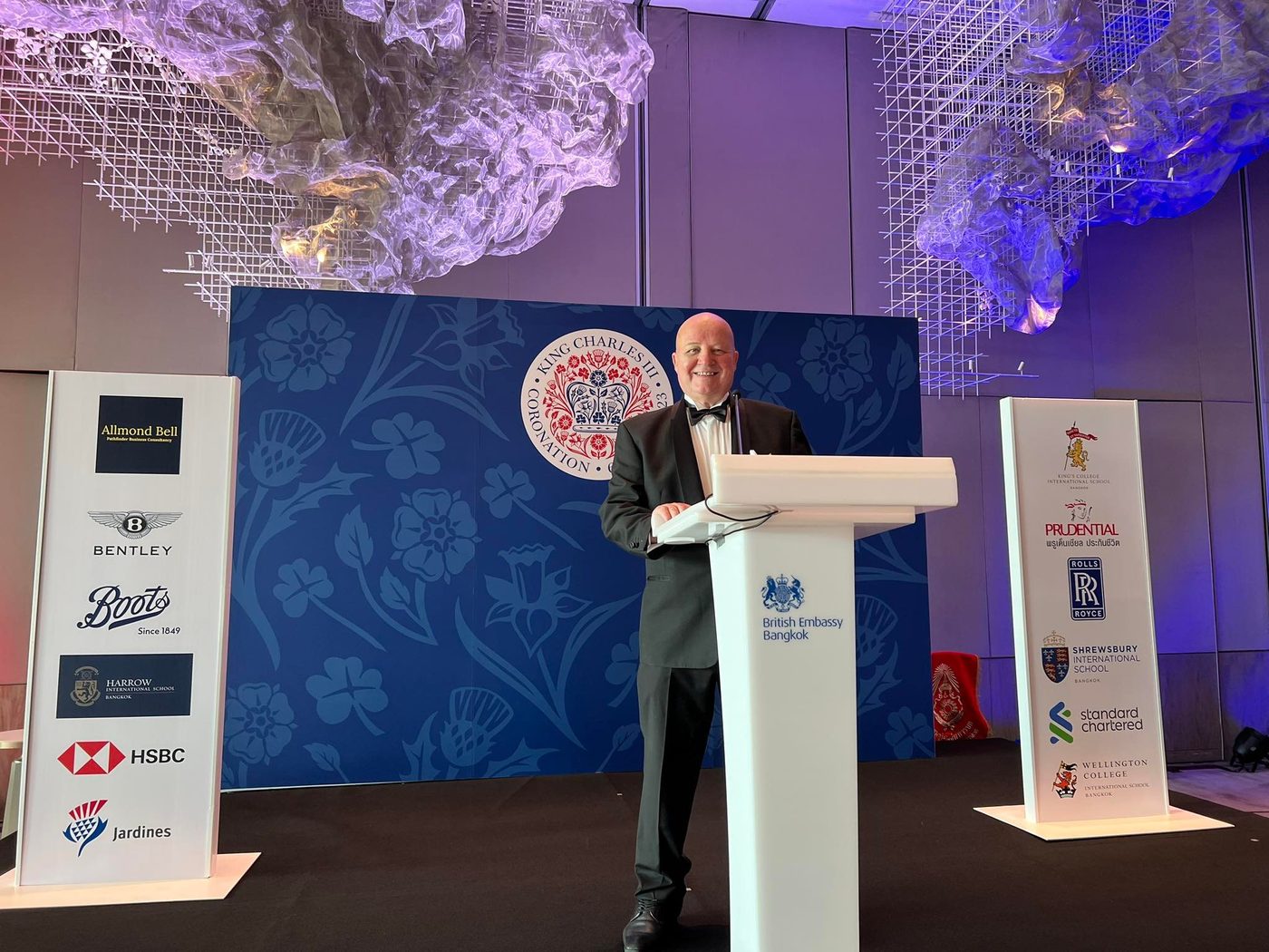 Nigel Allmond speaking at a lectern at the British Embassy Bangkok